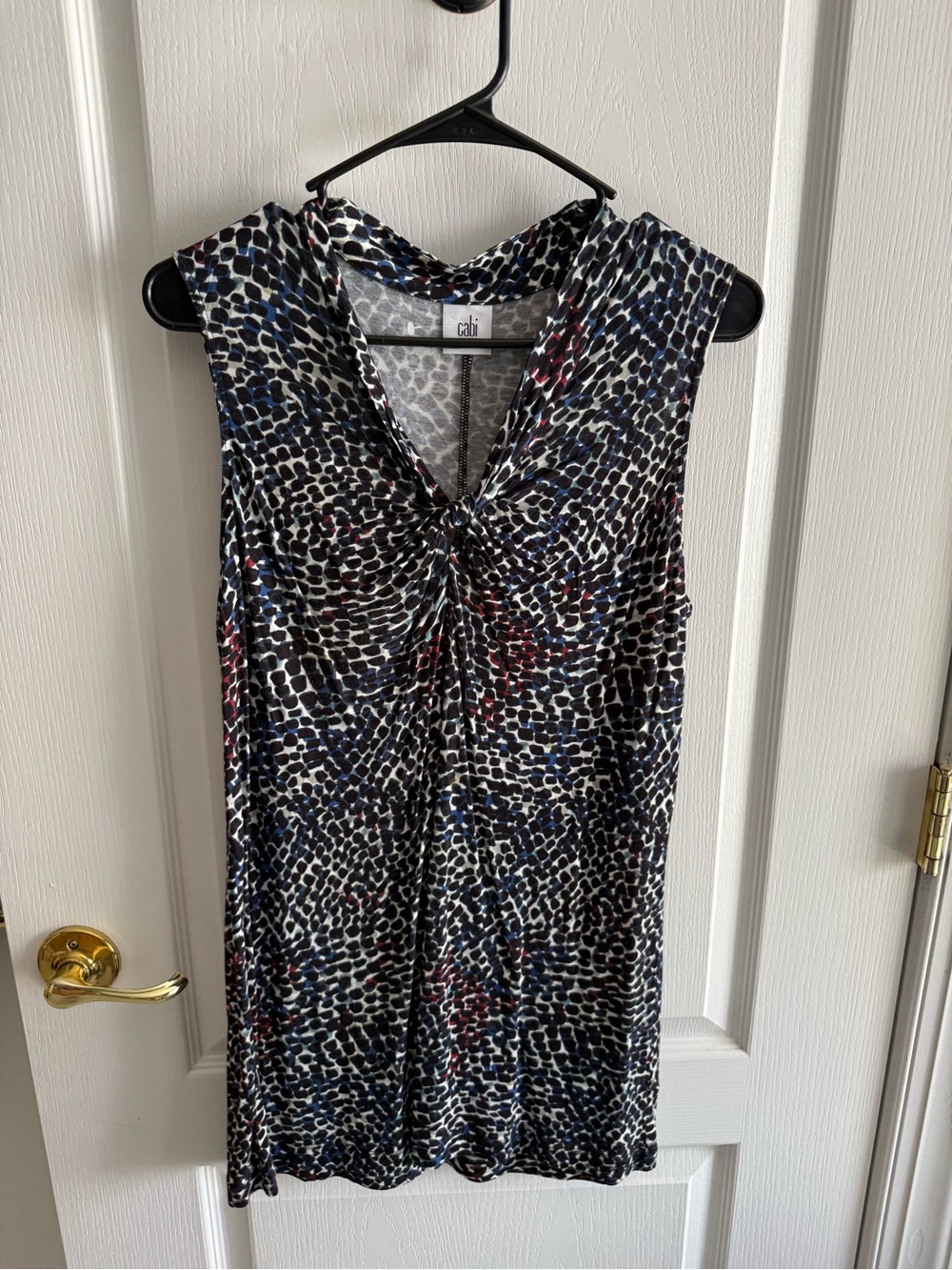 CAbi Sleeveless Twist-Front Animal Print Top in Black, White, Blue and Red